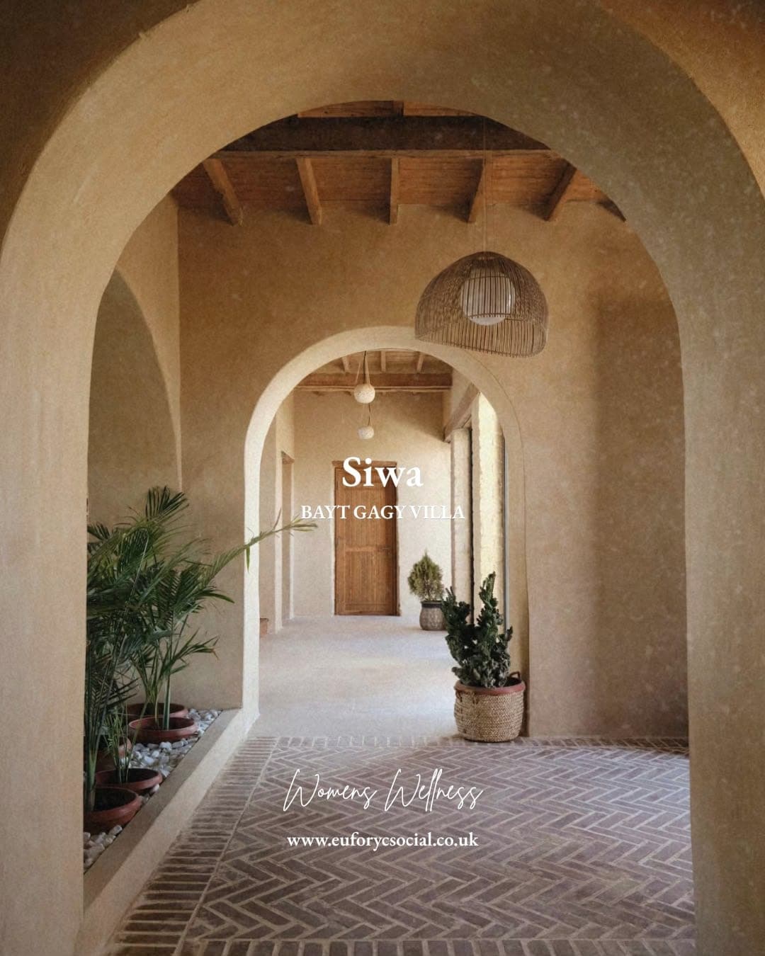 Arched corridors at Bayt Gagy Villa, herringbone brick underfoot and palms along the wall