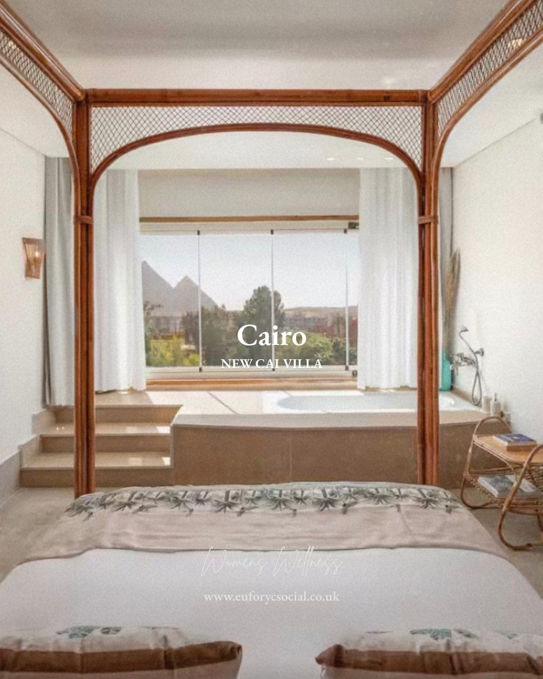 A four-poster bedroom at New Cai Villa, a sunken bath under the window and the pyramids beyond